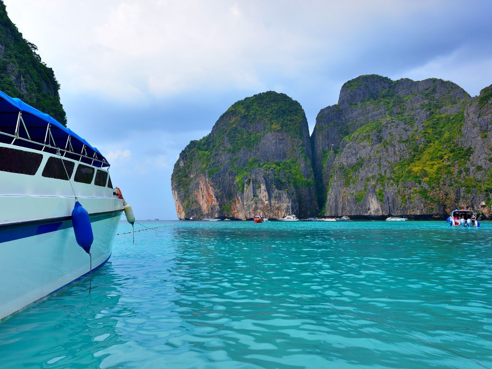 Itinerary Thailand Vegetarian Festival Longtail boat arriving at the Phi Phi Islands, Thailand