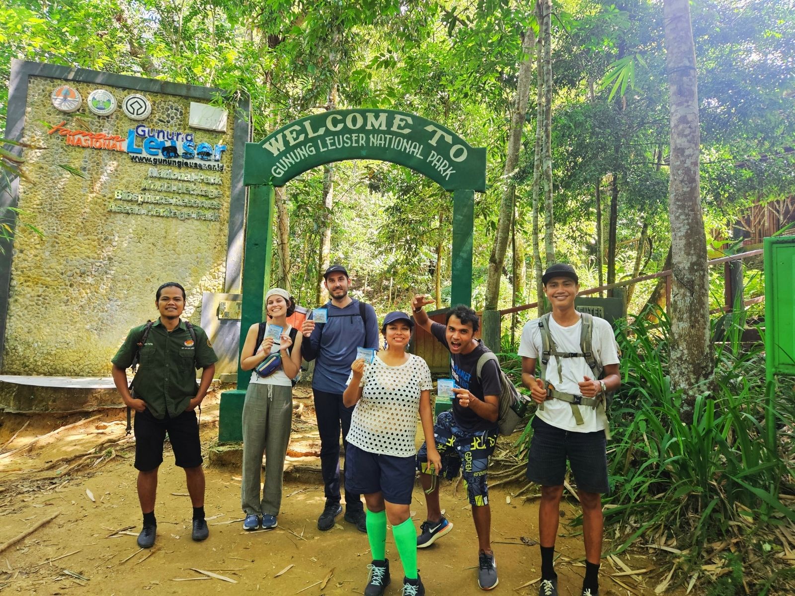 Vegan travel group hiking through lush rainforest in Gunung Leuser National Park in Sumatra, Indonesia