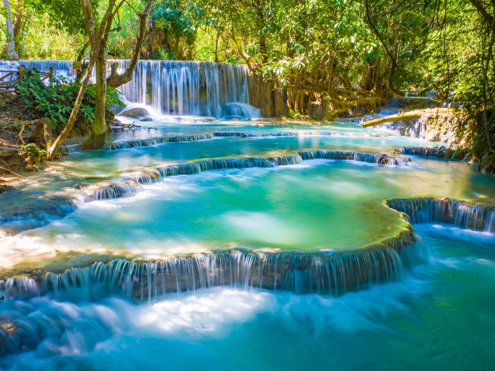 Kuang Si Waterfalls surrounded by lush forest in Laos