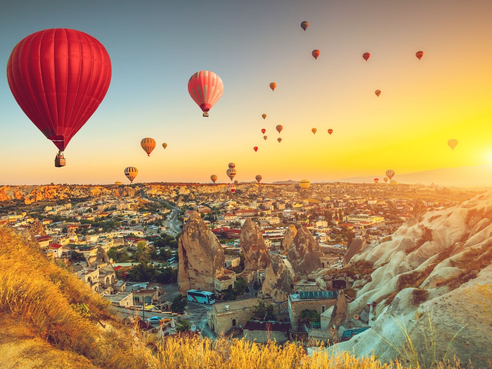 Hot air balloons soaring over Cappadocia at sunrise in Türkiye